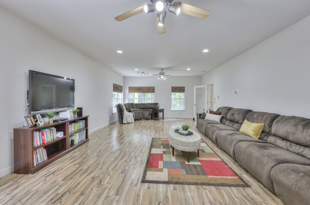 living room with light wood-type flooring and ceiling fan