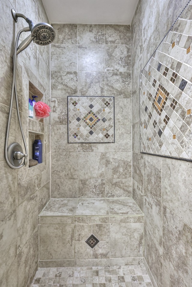 bathroom with tiled shower