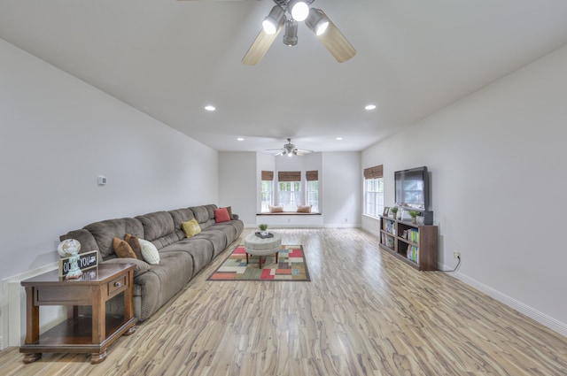 living room with ceiling fan and light hardwood / wood-style floors