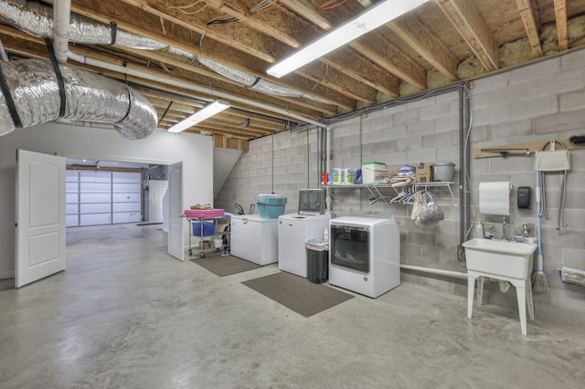 basement with washer and dryer, sink, and white refrigerator