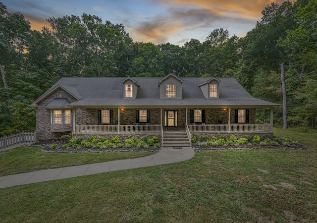 view of front facade featuring a porch and a lawn