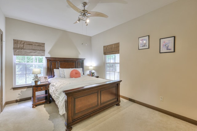 bedroom with ceiling fan and light carpet