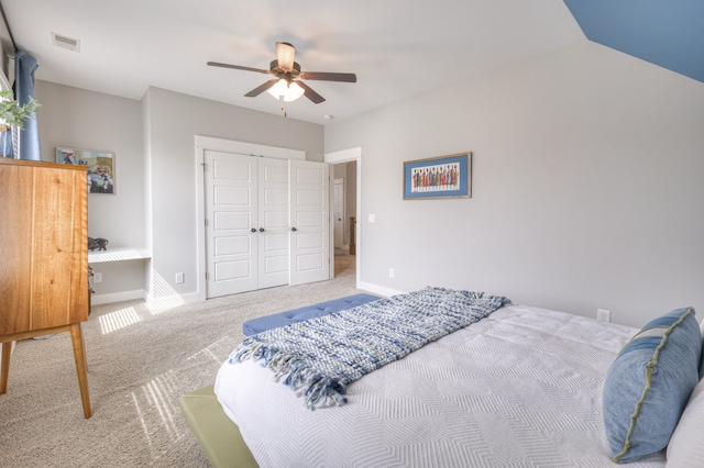 carpeted bedroom with lofted ceiling, ceiling fan, and a closet