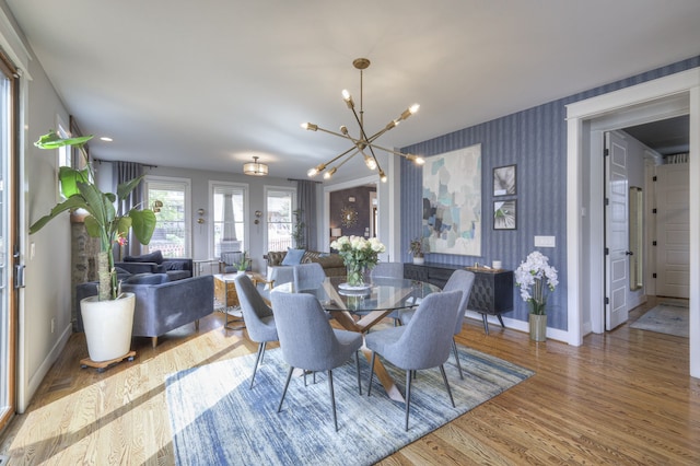 dining room featuring hardwood / wood-style flooring and a chandelier