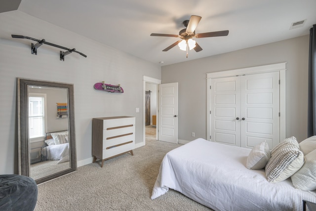 bedroom featuring lofted ceiling, light colored carpet, ceiling fan, and a closet