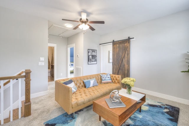 carpeted living room featuring a barn door