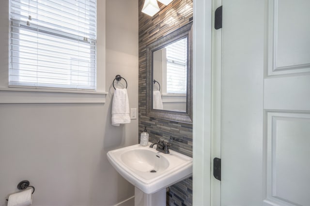 bathroom featuring sink and tasteful backsplash