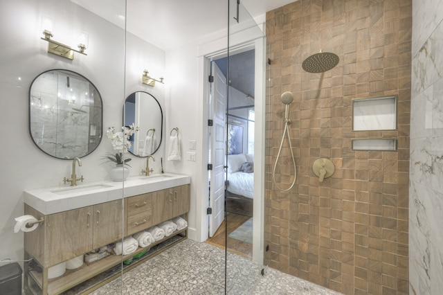 bathroom featuring vanity and tiled shower