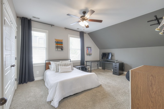 carpeted bedroom with vaulted ceiling and ceiling fan