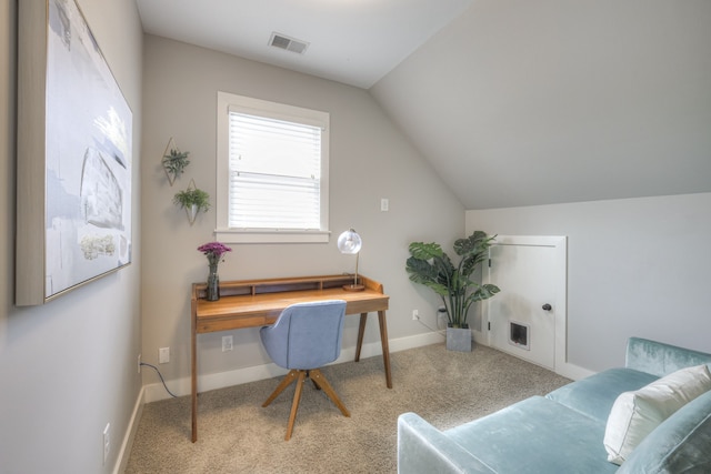 carpeted home office with lofted ceiling