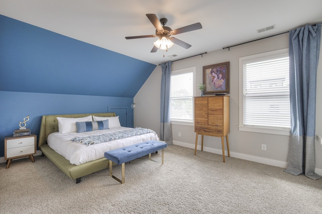 bedroom with lofted ceiling, multiple windows, ceiling fan, and carpet floors