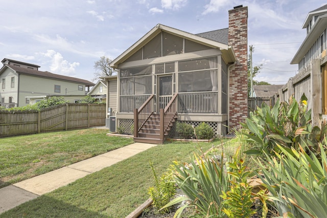 exterior space featuring a sunroom and a front lawn