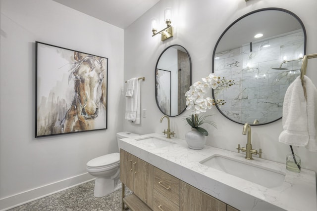 bathroom with vanity, toilet, and a shower