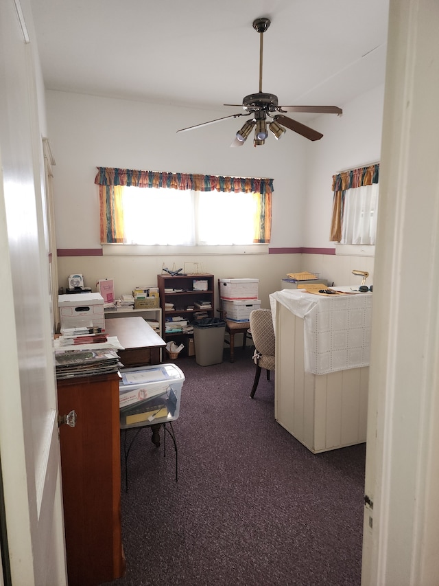 carpeted office space featuring ceiling fan