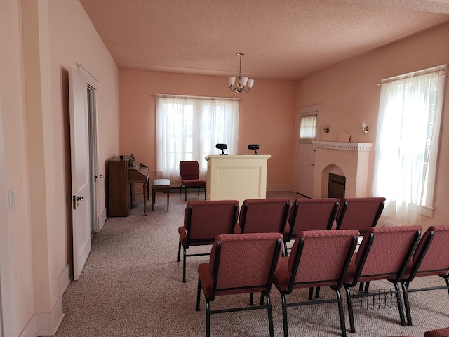 405 S Jackson St, Tullahoma, TN 37388 - dining area with a textured ceiling, light colored carpet, baseboards, and an inviting chandelier
