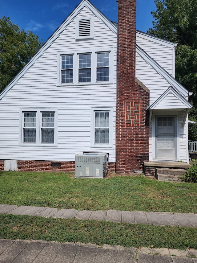 405 S Jackson St, Tullahoma, TN 37388 - view of property exterior featuring central AC, a yard, crawl space, and a chimney