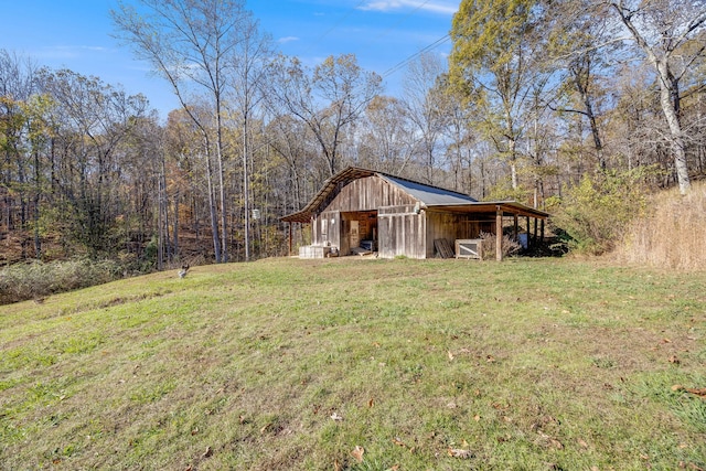 exterior space with a forest view and an outbuilding