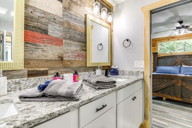 bathroom featuring vanity, wood-type flooring, and ceiling fan