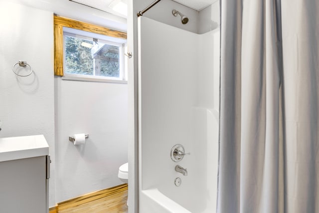 full bathroom featuring shower / bath combo with shower curtain, toilet, hardwood / wood-style floors, and vanity