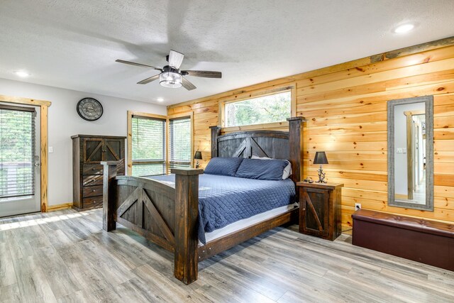 bedroom with hardwood / wood-style flooring, ceiling fan, and access to outside