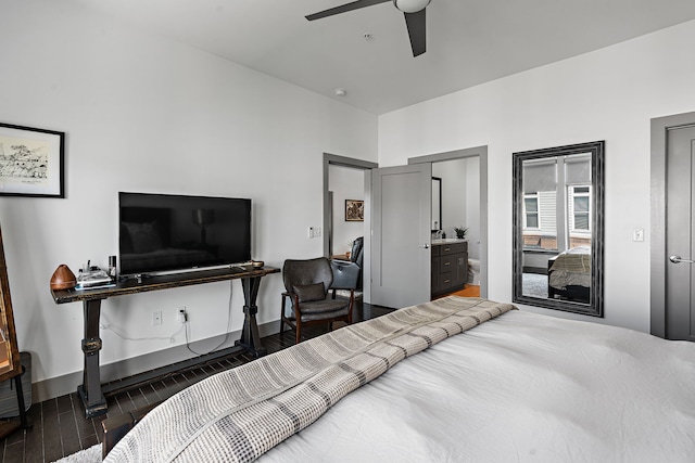 bedroom with dark wood-type flooring, ensuite bathroom, and ceiling fan