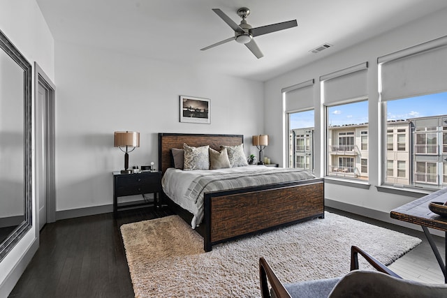 bedroom with dark wood-type flooring and ceiling fan