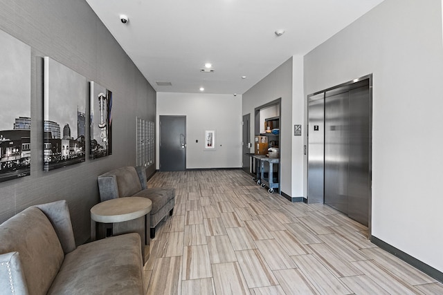 interior space with elevator and light hardwood / wood-style floors