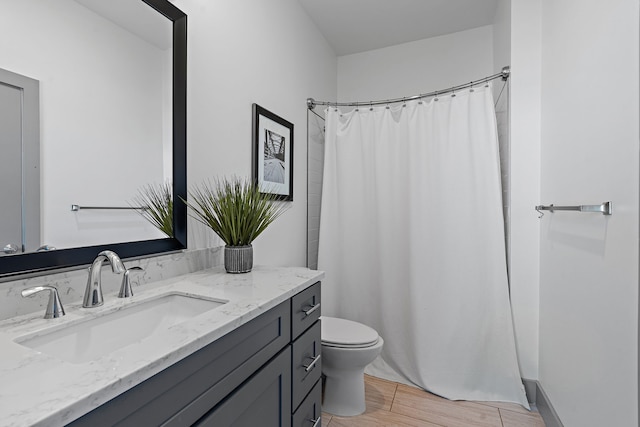 bathroom with vanity, toilet, hardwood / wood-style floors, and curtained shower