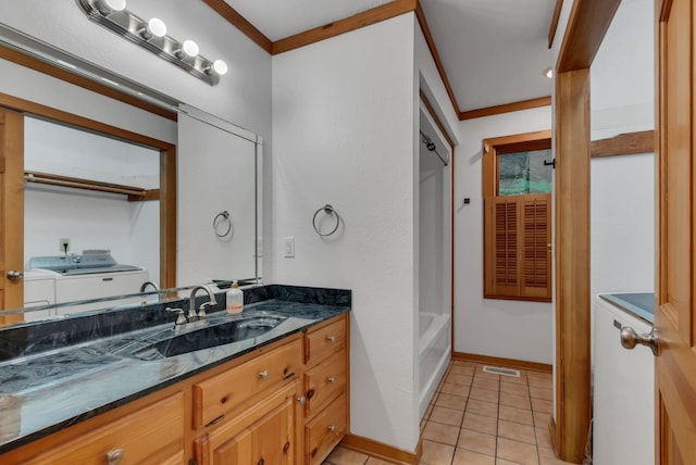 bathroom featuring independent washer and dryer, tile patterned floors, crown molding, vanity, and shower with separate bathtub