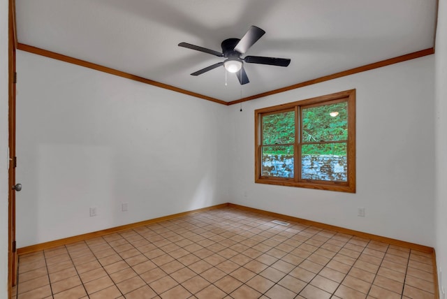 tiled spare room with ceiling fan and crown molding