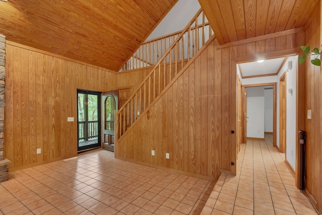 stairs with wood walls, tile patterned flooring, and wooden ceiling