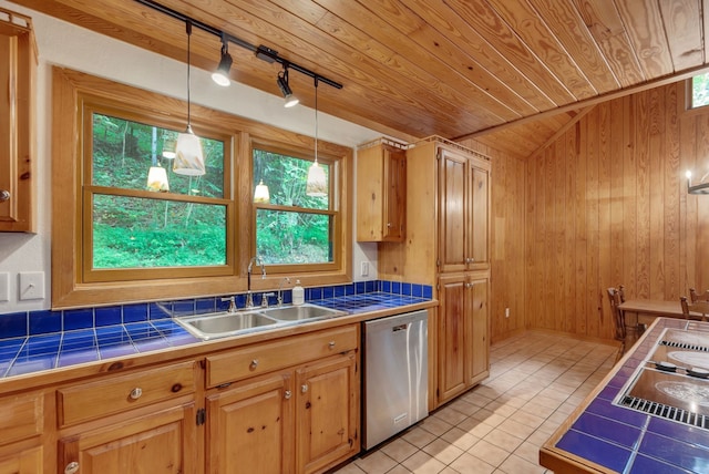 kitchen featuring dishwasher, light tile patterned floors, decorative light fixtures, tile countertops, and lofted ceiling