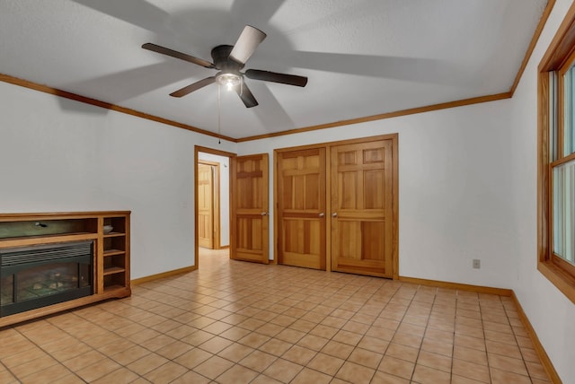 interior space with ornamental molding, light tile patterned flooring, and ceiling fan