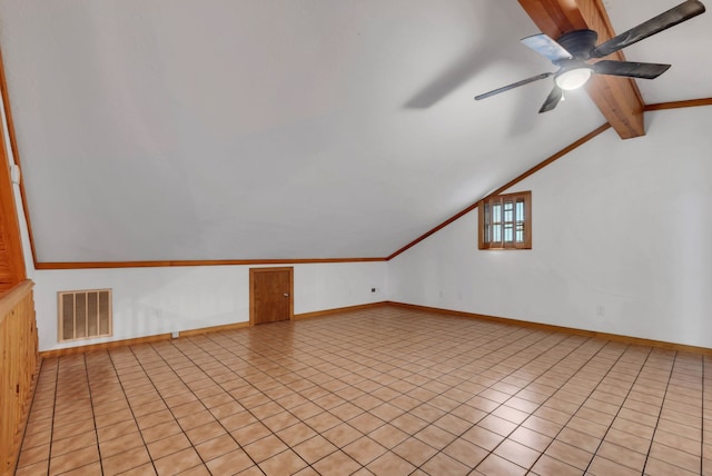 additional living space featuring ceiling fan, light tile patterned floors, and lofted ceiling with beams