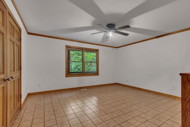 tiled spare room with ceiling fan, crown molding, and a textured ceiling