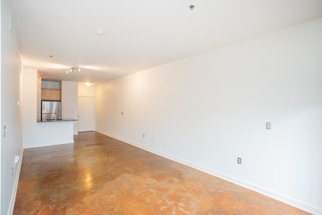 unfurnished living room featuring concrete flooring