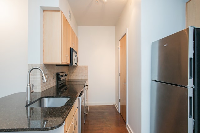 kitchen featuring tasteful backsplash, stainless steel appliances, sink, light brown cabinets, and dark stone counters