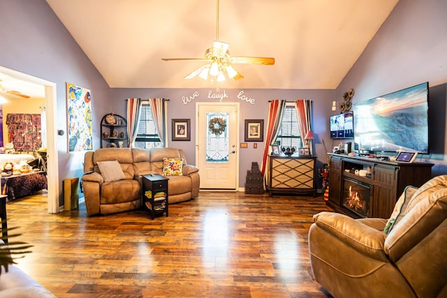 living room featuring a ceiling fan, lofted ceiling, and wood finished floors