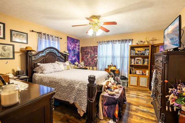 bedroom featuring a textured ceiling, ceiling fan, and wood finished floors