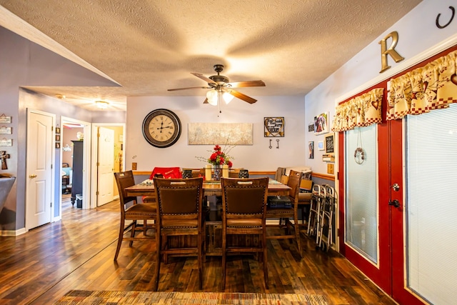 dining area with ceiling fan, wood-type flooring, and a textured ceiling