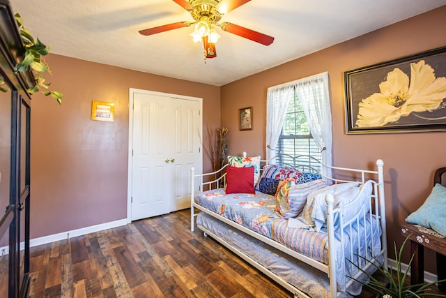 interior space featuring a ceiling fan, baseboards, and wood finished floors