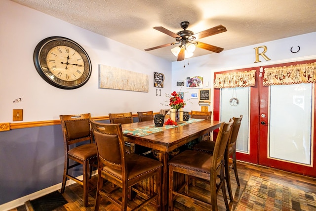 dining space featuring dark wood-style floors, french doors, a textured ceiling, and baseboards