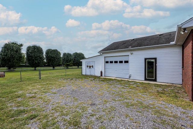 garage with driveway and fence