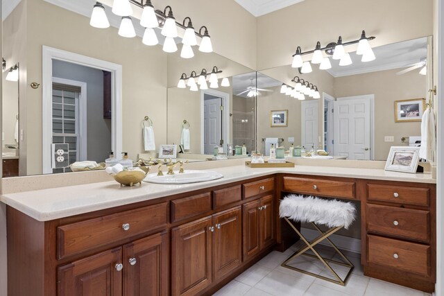 bathroom featuring tile patterned floors, ornamental molding, ceiling fan, vanity, and walk in shower