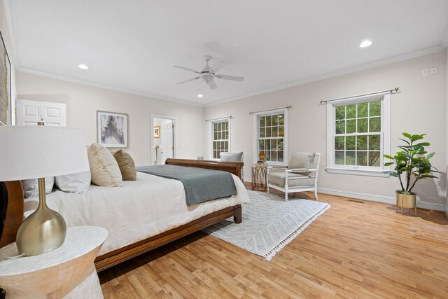 bedroom with ceiling fan, ornamental molding, light hardwood / wood-style flooring, and ensuite bath