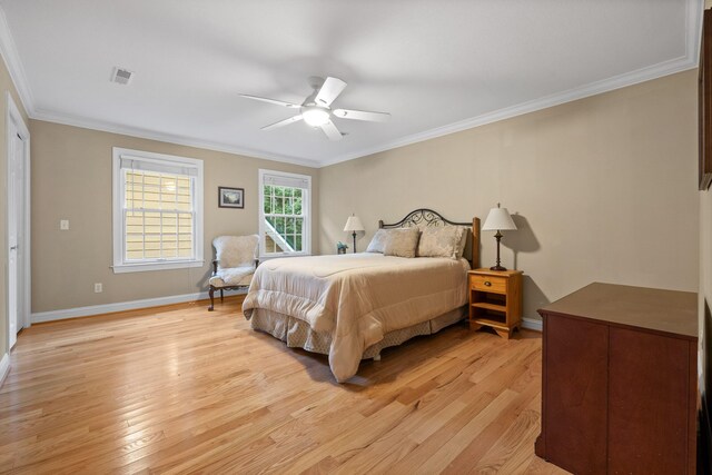 bedroom with ceiling fan, ornamental molding, and light wood-type flooring