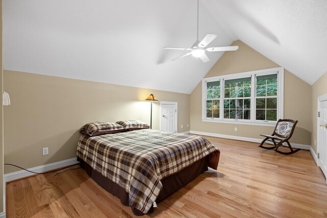 bedroom with light hardwood / wood-style floors, lofted ceiling, and ceiling fan