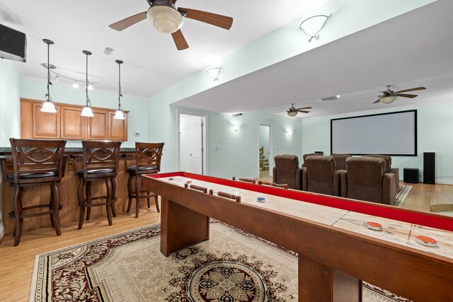 playroom featuring bar and light hardwood / wood-style flooring