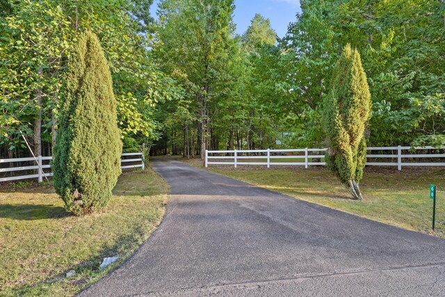 view of gate with a yard