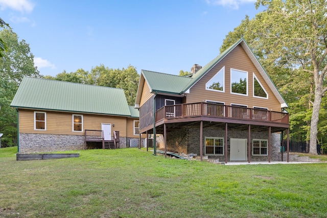 back of house with a wooden deck, a yard, and a patio area